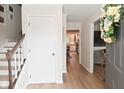 Inviting foyer featuring hardwood floors, a staircase, and views into the kitchen and living areas at 4585 Abbey Dr, Carmel, IN 46033