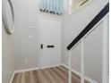 Clean entryway features light gray walls, a white front door, and wood-look flooring at 49 Druid Hill Ct # 0, Carmel, IN 46032