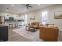 Bright, open-concept living area featuring modern furnishings that connect seamlessly to a stylish kitchen at 5511 E University Ave, Indianapolis, IN 46219