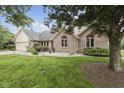Well maintained brick home with a manicured lawn and beautiful landscaping at 5591 Royal Troon Way, Avon, IN 46123