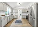 Open kitchen with white cabinets, stainless steel appliances, and view to dining area at 5982 Oak Hill East Dr, Plainfield, IN 46168