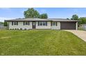 Charming exterior view of home with a manicured front lawn and a two-car garage at 6609 Cordova Ct, Indianapolis, IN 46221