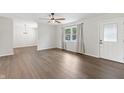Open living area with updated floors and natural light from the large window at 6609 Cordova Ct, Indianapolis, IN 46221