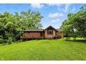 Spacious backyard with a well-maintained lawn, deck, and mature trees at 6655 Teeters Ln, Martinsville, IN 46151