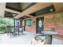 Inviting front porch featuring rocking chairs and a rustic table setting at 6655 Teeters Ln, Martinsville, IN 46151