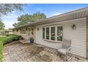 Inviting front porch with patterned concrete and a comfortable chair for enjoying outdoor relaxation at 7125 Chandler Dr, Indianapolis, IN 46217