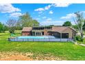 A backyard pool with slide, patio, and a charming home with mature trees and well-maintained lawn at 7165 W State Road 252 W Rd, Edinburgh, IN 46124