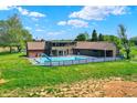 A backyard pool with slide, patio, and a charming home with mature trees and well-maintained lawn at 7165 W State Road 252 W Rd, Edinburgh, IN 46124