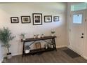 Inviting entryway with console table, decorative accents, and wood-look vinyl floors that leads into the home at 7270 W Stone Pass, New Palestine, IN 46163
