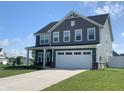 Charming two-story home with gray siding, white trim, a two-car garage, and a well-manicured lawn at 7270 W Stone Pass, New Palestine, IN 46163