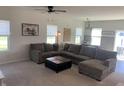 Comfortable living room with plush sectional sofa, carpet, and neutral decor that offers a cozy atmosphere at 7270 W Stone Pass, New Palestine, IN 46163