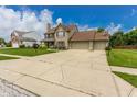 Spacious two-story home with a wide driveway, attached two-car garage, and well-kept lawn at 7710 Samuel Dr, Indianapolis, IN 46259