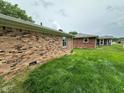 View of the expansive lawn behind the brick house at 8061 Sycamore Springs Trl, Indianapolis, IN 46239