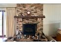 Close-up of a brick fireplace with mantel at 8061 Sycamore Springs Trl, Indianapolis, IN 46239