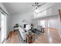 Spacious living room with hardwood floors, a fireplace, cathedral ceilings and a view of a second floor balcony at 8178 Foxchase Cir, Indianapolis, IN 46256