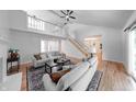 A open concept living room featuring hardwood floors, a fireplace, stairs to a second floor and an entryway at 8178 Foxchase Cir, Indianapolis, IN 46256