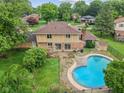 Aerial view of the home showcasing the patio, roof, yard, and the in-ground pool in the backyard at 904 Dreamy St, Greenwood, IN 46142