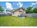 Spacious backyard featuring a small patio area with outdoor seating and a barbecue grill at 917 W 8Th St, Anderson, IN 46016