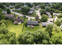 An aerial view showcasing a home with a fenced backyard and lush trees, creating a private outdoor space at 9265 Brunson Run, Indianapolis, IN 46256