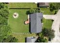 Overhead shot of a home featuring a wooden deck, fenced in yard, and mature trees surrounding the property at 9265 Brunson Run, Indianapolis, IN 46256