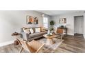 Bright living room features a comfy sofa, stylish decor, accent chairs, and plank flooring at 946 N Temple Ave, Indianapolis, IN 46201