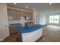 Spacious kitchen featuring gray cabinets, an island with sink, and countertops, ready for customization at 10604 Maidenhair Dr, Indianapolis, IN 46239