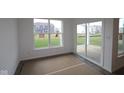Bright sun room with large windows and sliding glass doors to the patio, ready for relaxation at 10604 Maidenhair Dr, Indianapolis, IN 46239