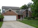 Charming two-story home with well-manicured lawn and a two-car garage and brick facade with a basketball hoop at 1067 Barley Cir, Carmel, IN 46032