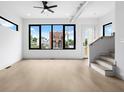 Spacious, light-filled living room with hardwood floors, large windows, and modern fixtures at 1100 English Ave, Indianapolis, IN 46203