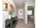 Bright entryway with light floors, a decorative table, and views of a bedroom at 11663 Winnower, Noblesville, IN 46060