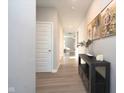 Hallway with light floors, decorative table, and views to the rest of the house at 11663 Winnower, Noblesville, IN 46060