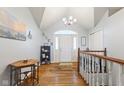 Inviting foyer with hardwood floors, light gray walls, and a vaulted ceiling at 1439 E Mckenzie Rd, Greenfield, IN 46140