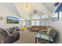 Bright living room with vaulted ceilings, arched windows, and comfortable seating at 1439 E Mckenzie Rd, Greenfield, IN 46140