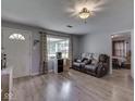 Bright living room features a view to the exterior and laminate wood flooring at 1603 S Morgantown Rd, Greenwood, IN 46143