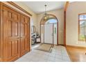 Welcoming foyer with tiled flooring, arched doorway, closet, and elegant lighting at 1682 S Fox Cove Blvd, New Palestine, IN 46163