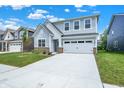 Charming two-story home with light-blue siding, white trim and a two car garage at 16929 Sandhurst Pl, Westfield, IN 46074