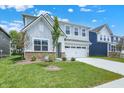 Charming two-story home with light-blue siding, white trim and a two car garage at 16929 Sandhurst Pl, Westfield, IN 46074