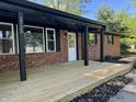 Newly constructed wooden front porch and red brick exterior enhance this home's curb appeal at 1725 E 100 S, Lebanon, IN 46052
