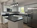 Modern kitchen featuring stainless steel appliances, white cabinets, and a stylish island at 1725 E 100 S, Lebanon, IN 46052