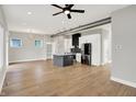 Open-concept living space featuring hardwood floors and a modern kitchen with stainless appliances at 2008 Yandes St, Indianapolis, IN 46202
