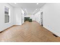 Bright, open-concept living space with hardwood floors and ample natural light at 206 N Beville Ave, Indianapolis, IN 46201