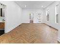 A stylish living area featuring luxury vinyl flooring, complemented by bright natural light at 206 N Beville Ave, Indianapolis, IN 46201