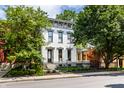Attractive two-story house with a manicured lawn, mature trees, and a decorative black metal fence at 214 E St Joseph St, Indianapolis, IN 46202
