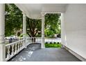 View of the front porch featuring classic white columns and a curved balustrade at 214 E St Joseph St, Indianapolis, IN 46202