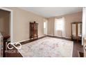 The living room features a decorative rug and is well lit with neutral colored walls at 2410 S Ebright St, Muncie, IN 47302