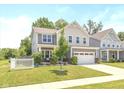 Charming two-story home featuring a well-manicured lawn and attached two-car garage at 265 Gathering Ln, Greenwood, IN 46143