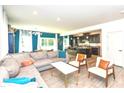 Open-concept living room and kitchen with modern finishes and ample natural light at 265 Gathering Ln, Greenwood, IN 46143