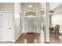 Bright foyer featuring hardwood floors, arched doorways, and a view into the dining area at 2920 Bloomsbury S, Greenwood, IN 46143