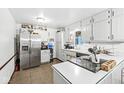 Bright kitchen with white cabinets, stainless steel appliances, and a view of the backyard at 3090 N County Road 800 E Rd, Brownsburg, IN 46112