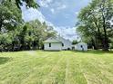 Spacious backyard with lush green grass and mature trees, perfect for outdoor activities and relaxation at 3712 S Kealing S Ave, Indianapolis, IN 46237
